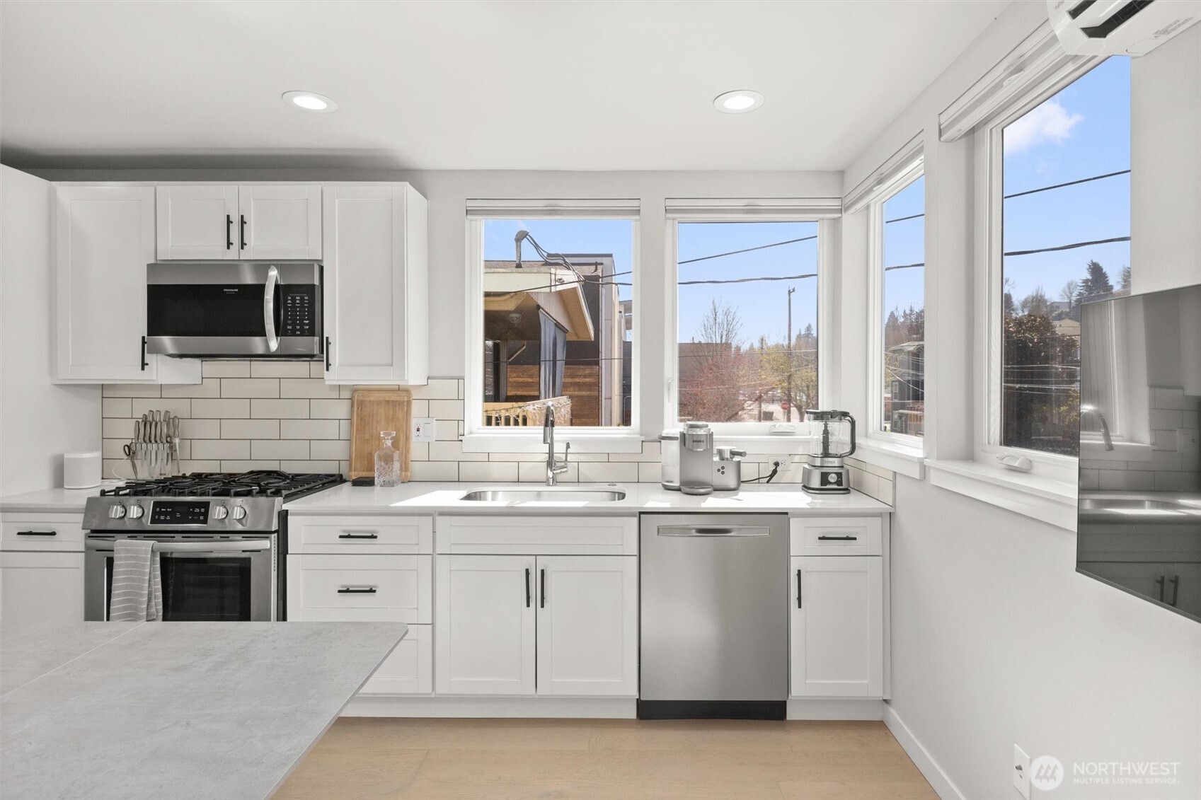 3638 36th Avenue South, Unit D Seattle, WA 98144 - Photo 12 of 21 a kitchen with stainless steel appliances a stove sink microwave and cabinets