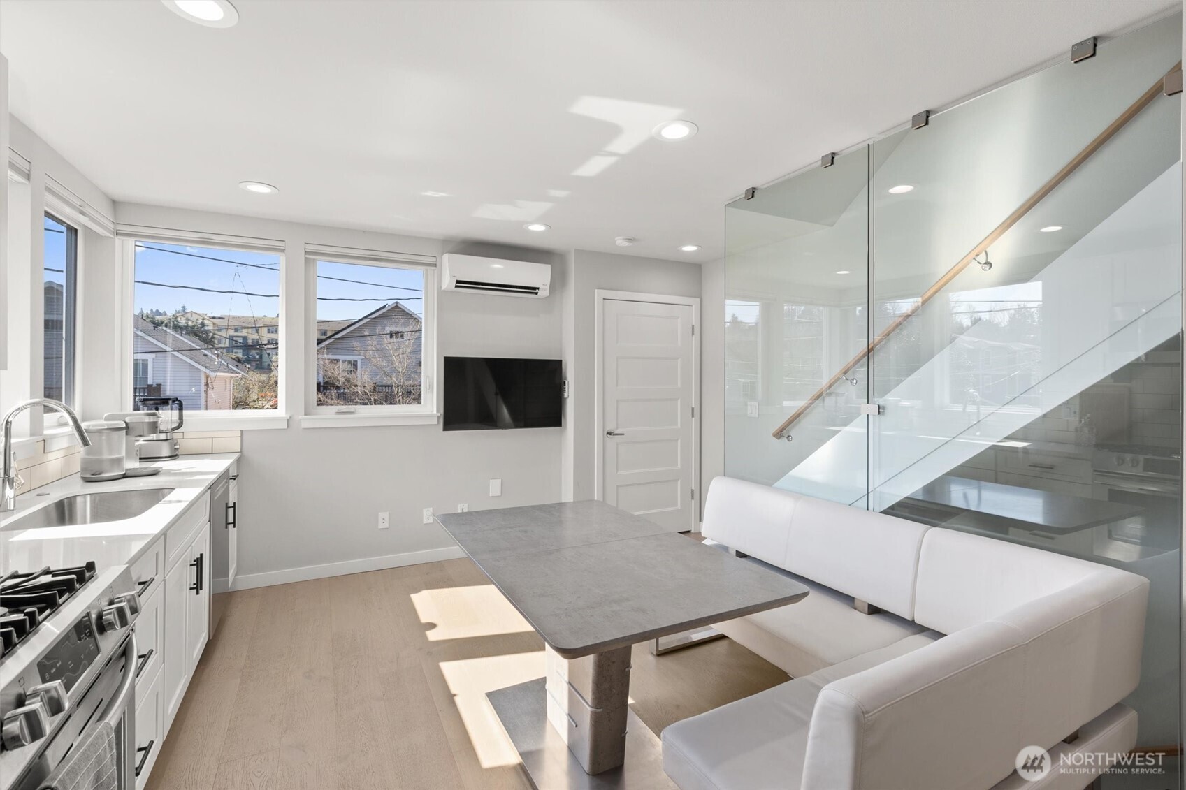 3638 36th Avenue South, Unit D Seattle, WA 98144 - Photo 13 of 21 a kitchen with a sink and white cabinets with wooden floor