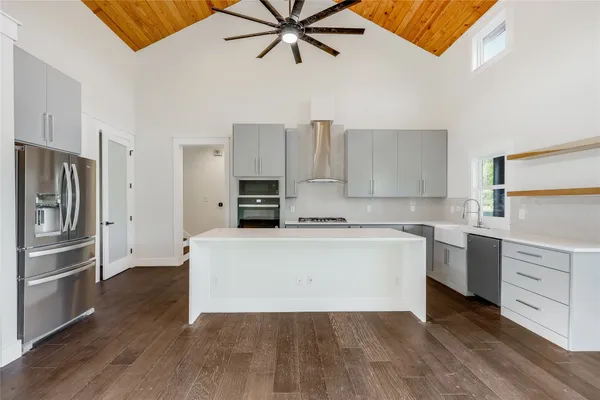 a view of a hallway with wooden floor and a living room