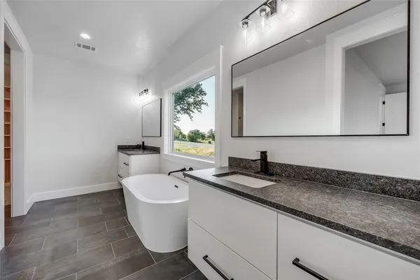 a bathroom with a bathtub and shower