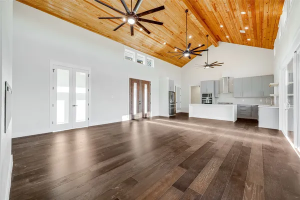 a kitchen with cabinets stainless steel appliances and wooden floor