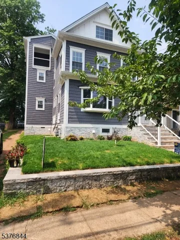 a front view of a house with a yard and a garage