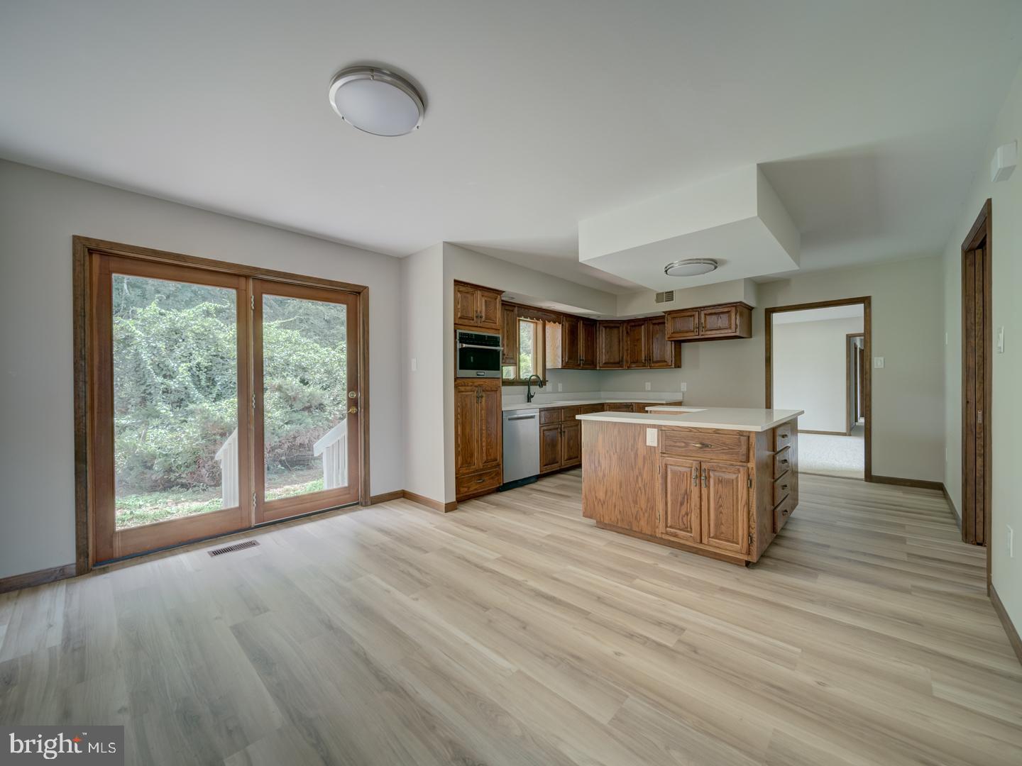 2750 Ridge Road Westminster, MD 21157 - Photo 11 of 57 a large kitchen with stainless steel appliances granite countertop a large counter top and wooden floors
