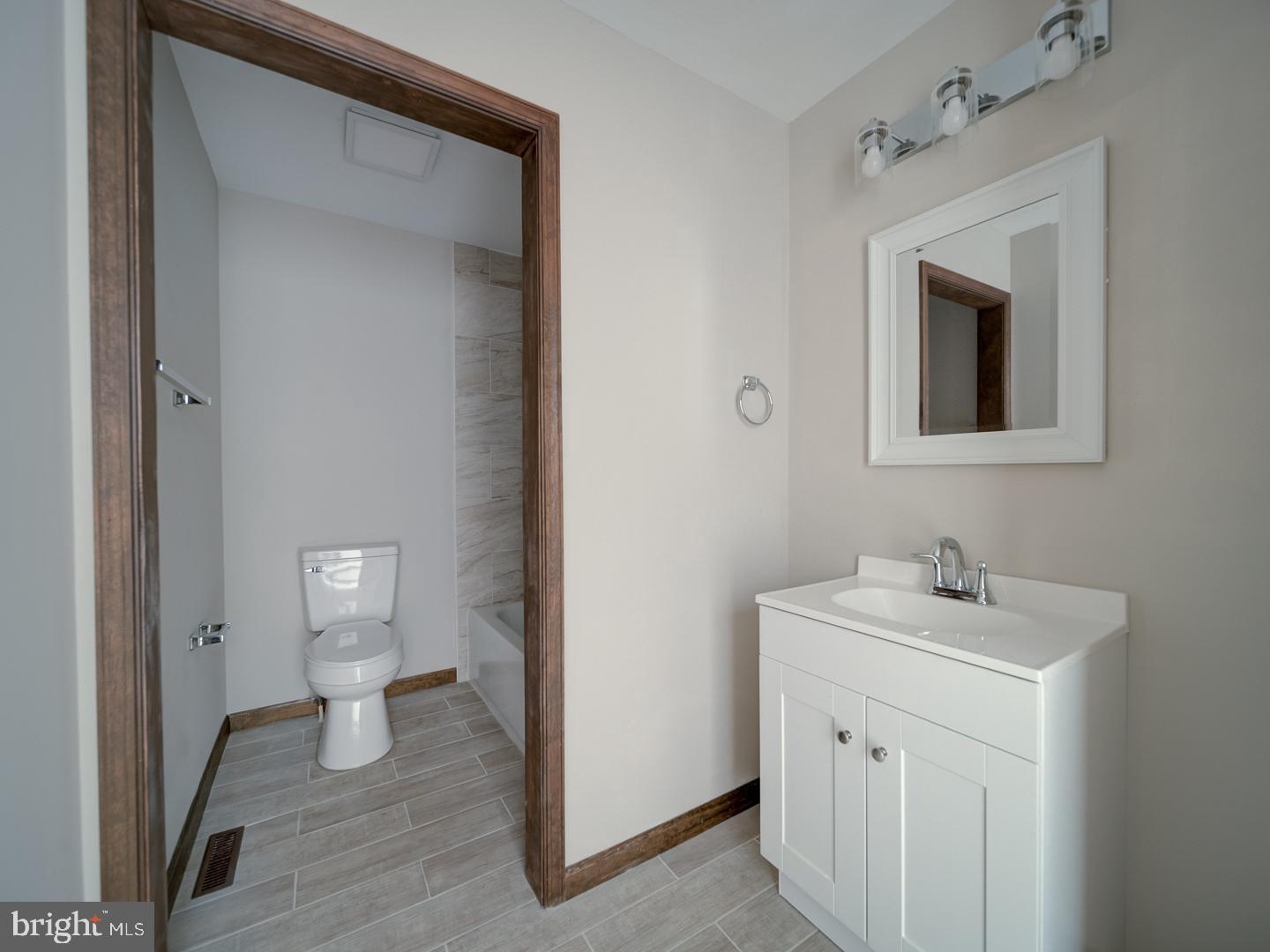 2750 Ridge Road Westminster, MD 21157 - Photo 35 of 57 a bathroom with a toilet sink and mirror
