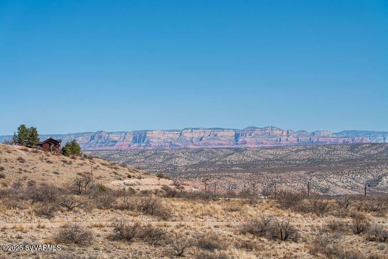 1160 Horny Toad Road Clarkdale, AZ 86324 - Photo 10 of 14 a view of a dry yard with wooden fence