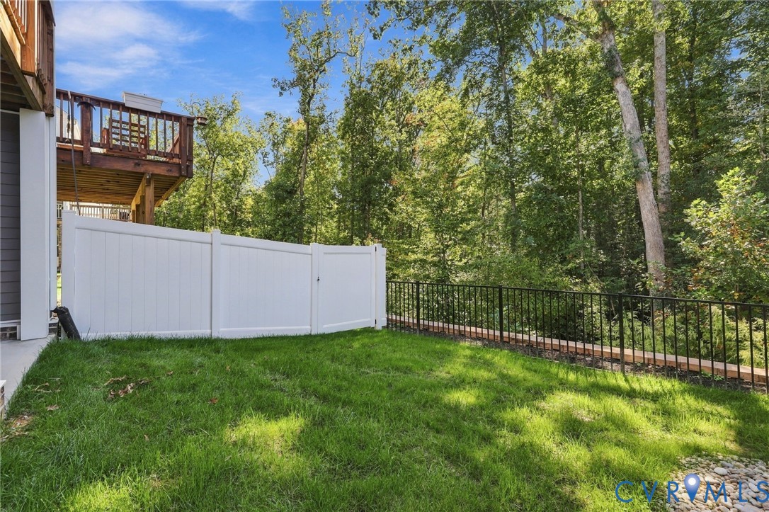 12824 Deep Wl Road Midlothian, VA 23112 - Photo 39 of 42 Expansive grassy yard with a white privacy fence,