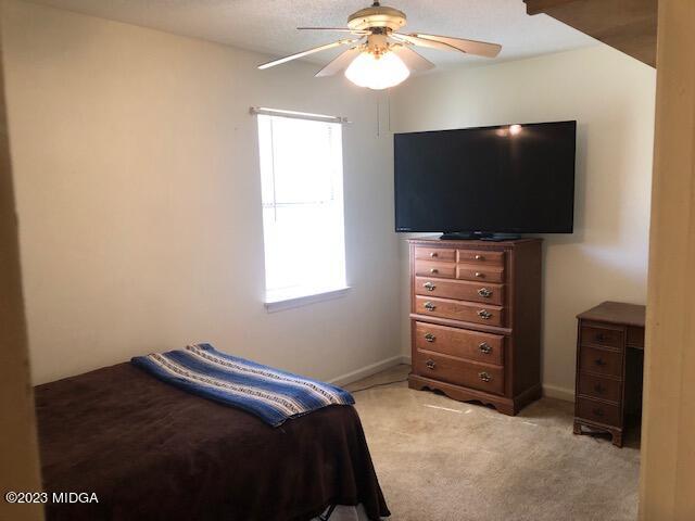 745 Taylor Road Juliette, GA 31046 - Photo 9 of 16 a bedroom with a bed and a flat screen tv