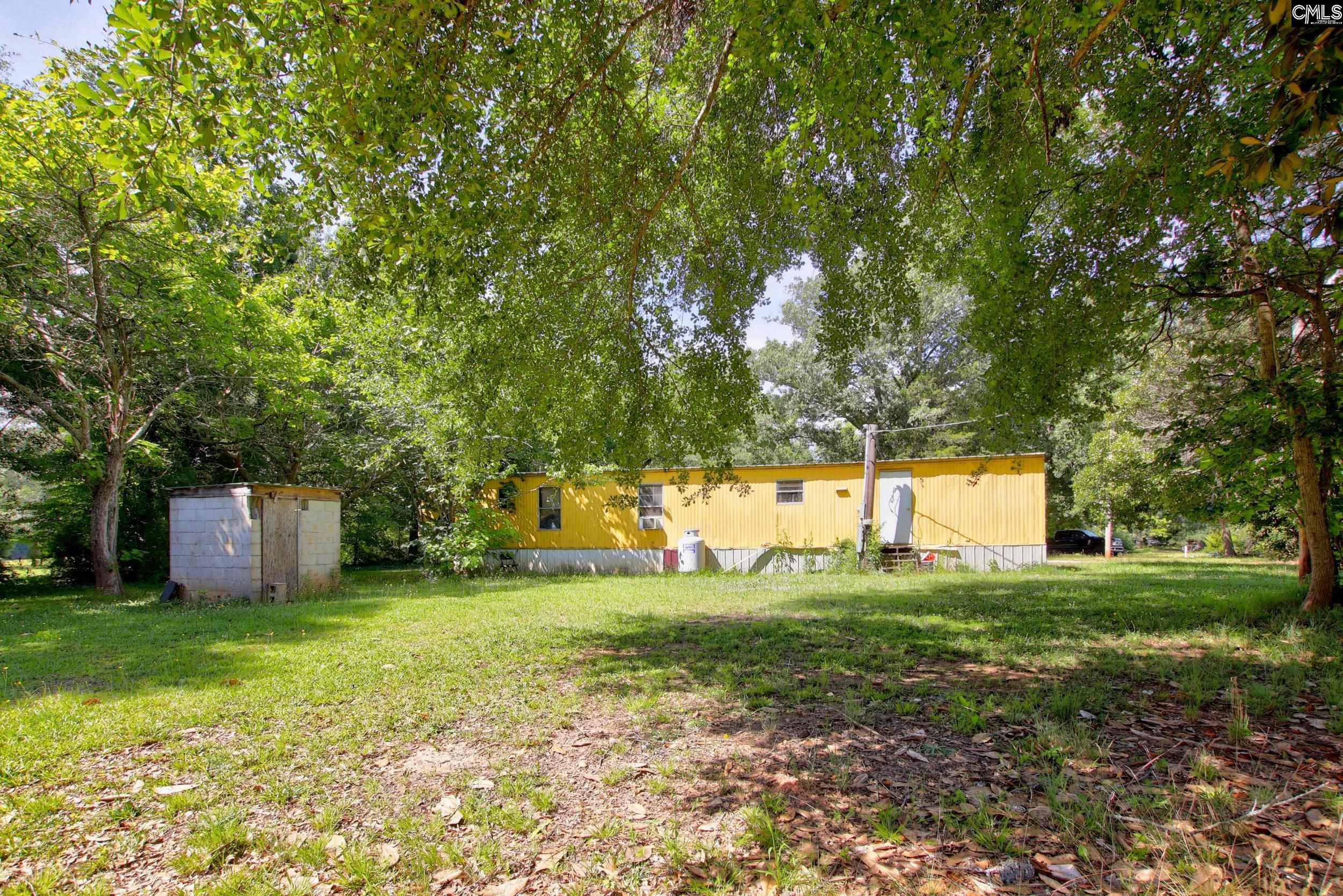 3140 Highway 702 Chappells, SC 29037 - Photo 38 of 39 a view of a house with backyard and trees