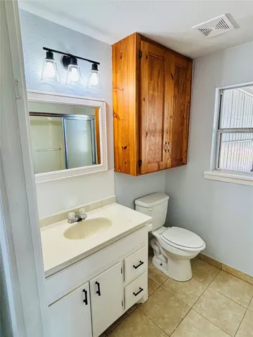 a bathroom with a sink a toilet and mirror