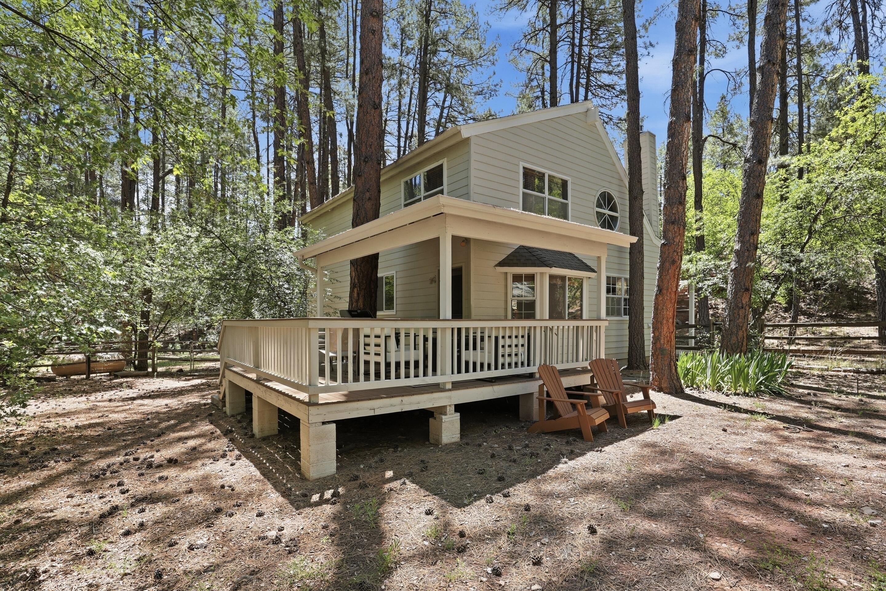 6322 Sharyn Road Pine, AZ 85544 - Photo 27 of 37 a view of a house with a yard and deck