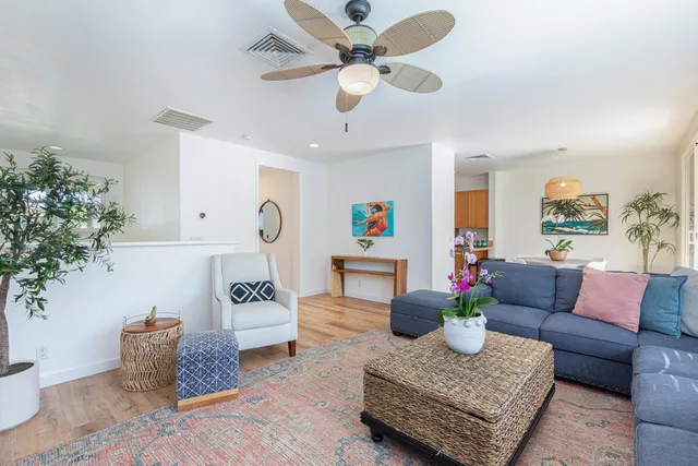 a living room with furniture and a potted plant