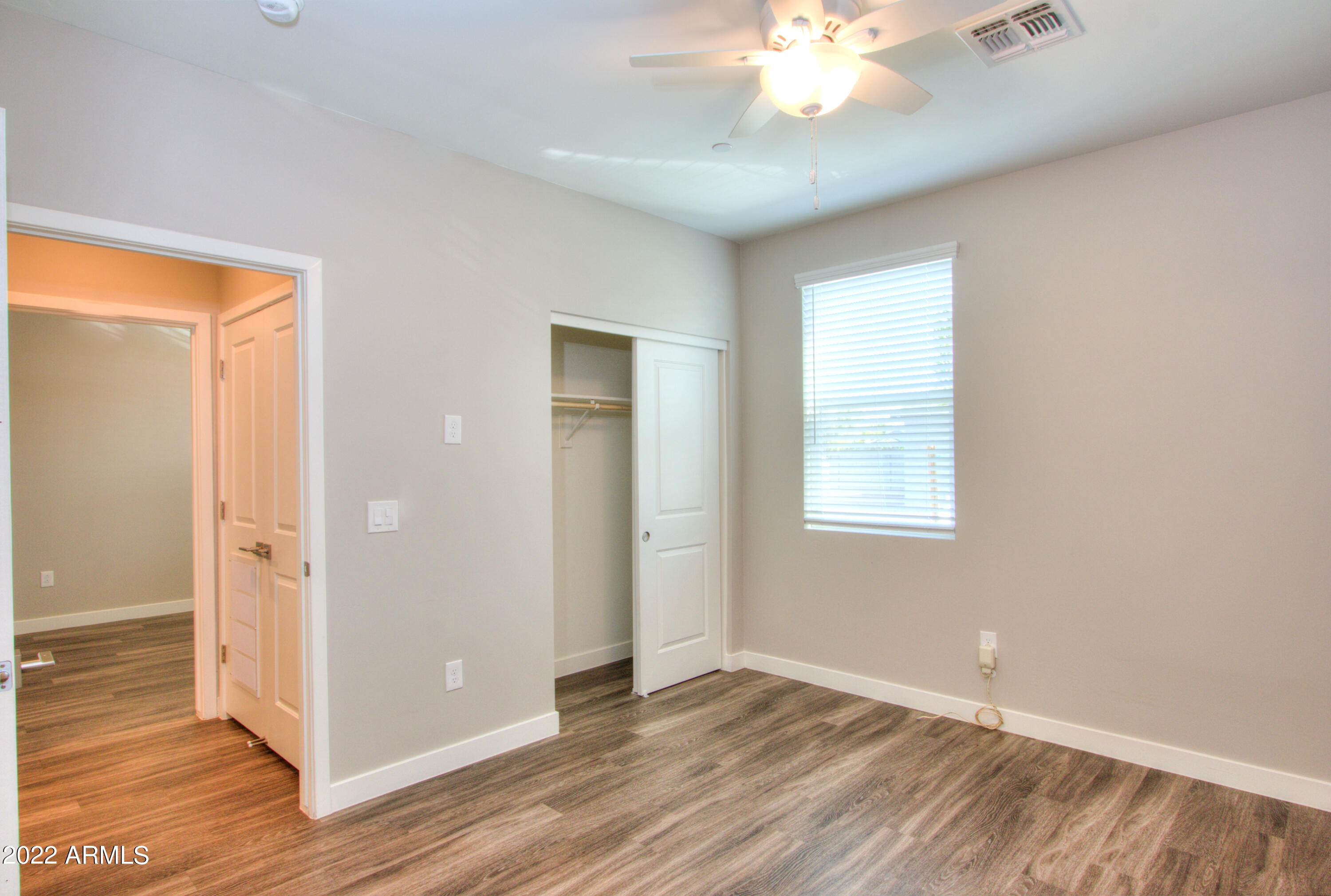 2245 North Dayton Street, Unit 3 Phoenix, AZ 85006 - Photo 13 of 26 a view of an empty room with wooden floor and a window
