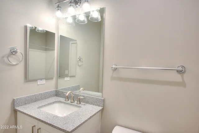 a bathroom with a sink vanity and a mirror