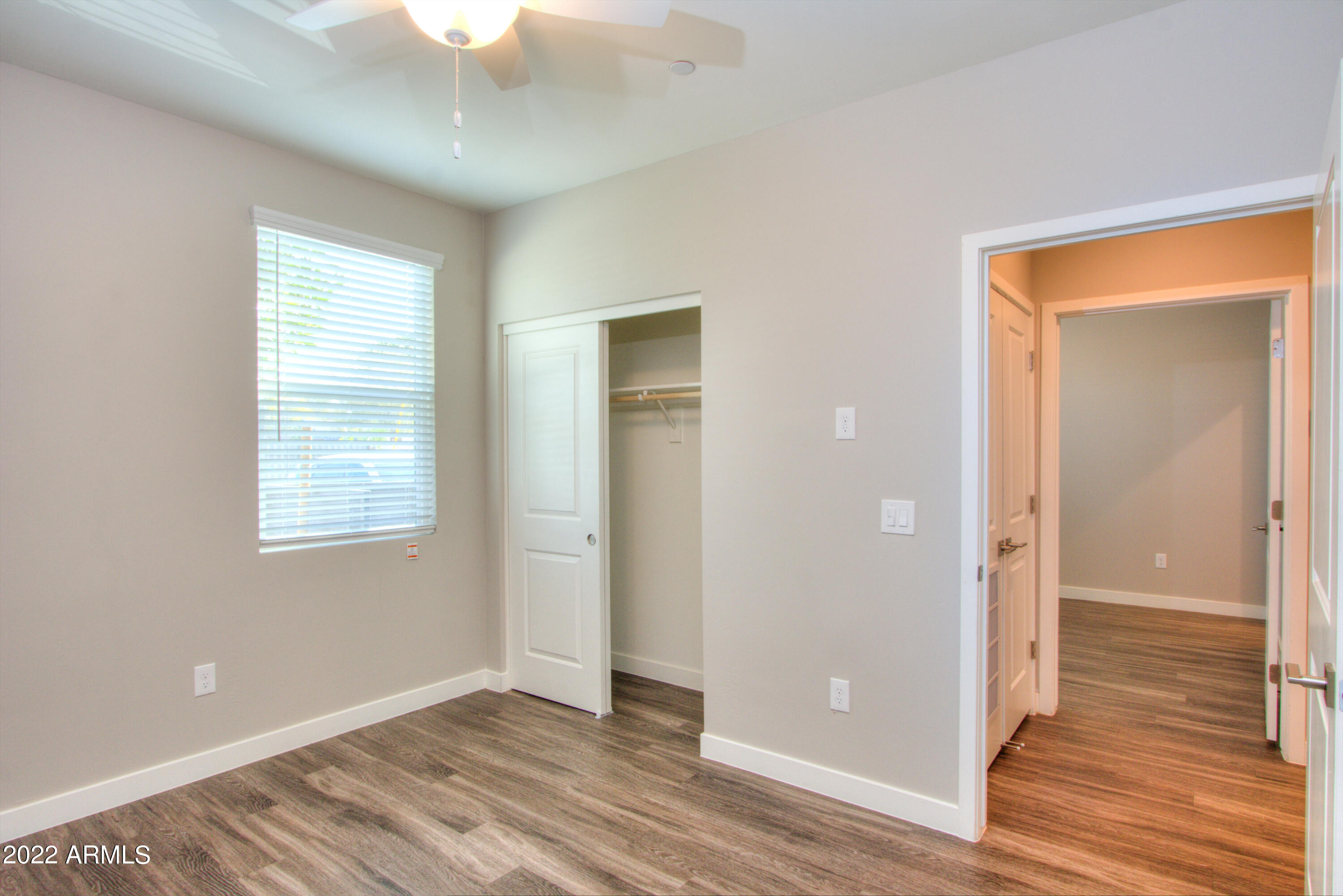 2245 North Dayton Street, Unit 3 Phoenix, AZ 85006 - Photo 18 of 26 a view of an empty room with wooden floor and a window