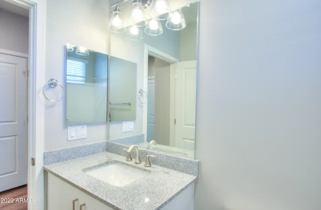 a bathroom with a sink vanity and a mirror
