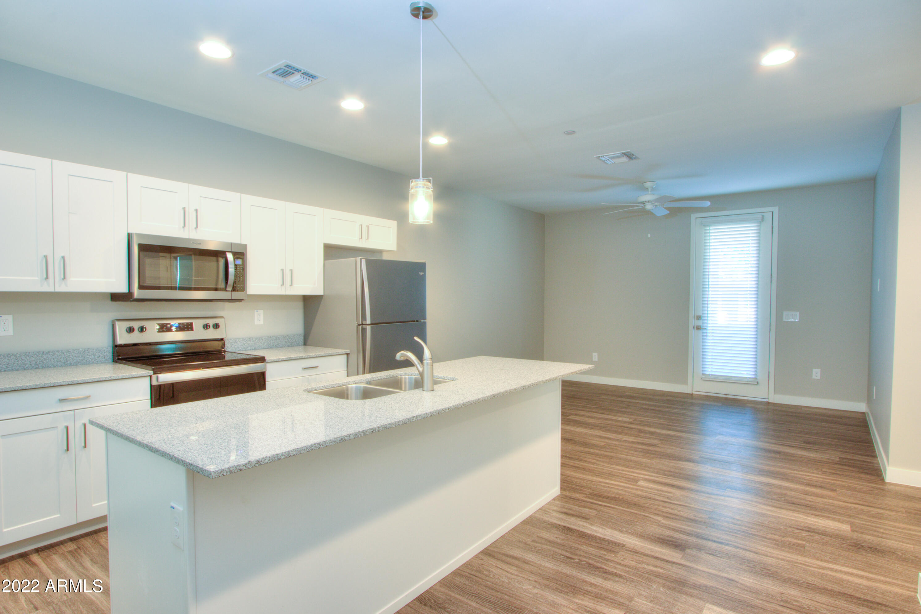 2245 North Dayton Street, Unit 3 Phoenix, AZ 85006 - Photo 8 of 26 a kitchen with stainless steel appliances a sink dishwasher stove refrigerator and microwave