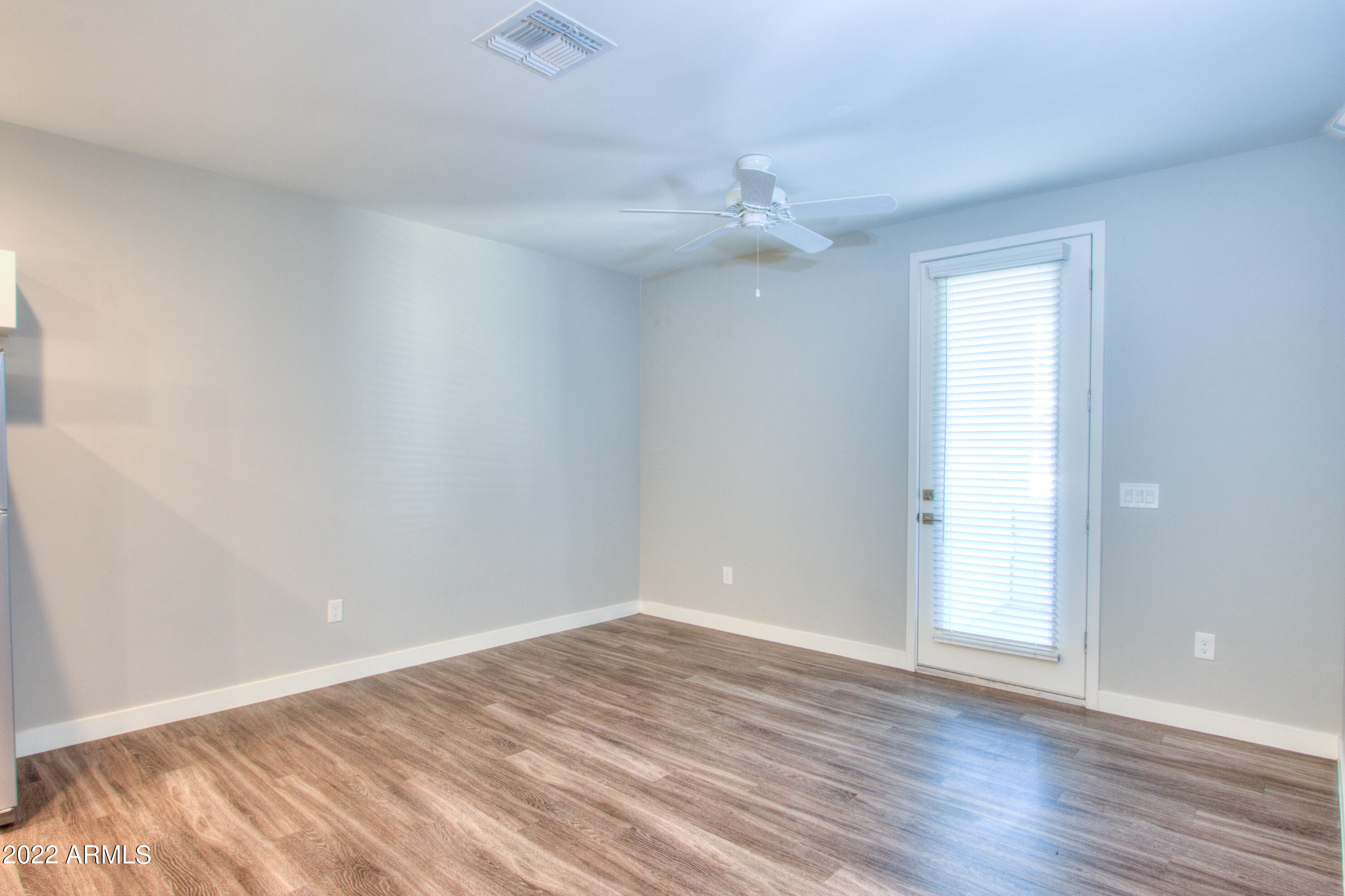 2245 North Dayton Street, Unit 3 Phoenix, AZ 85006 - Photo 9 of 26 an empty room with wooden floor and ceiling fan