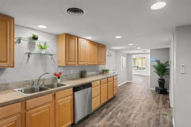 a kitchen with sink cabinets and wooden floor