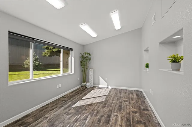 wooden floor in an empty room with a window