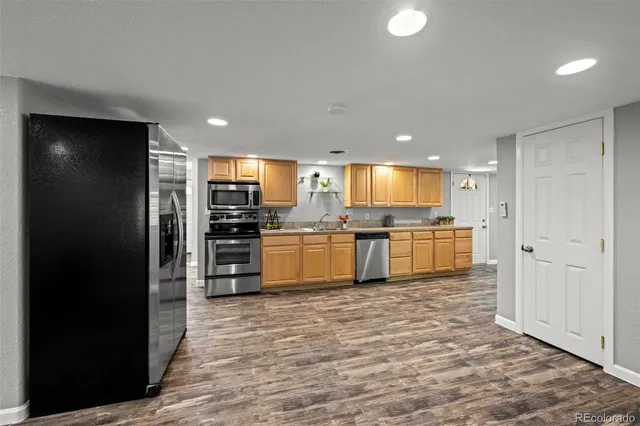 a large kitchen with cabinets and stainless steel appliances