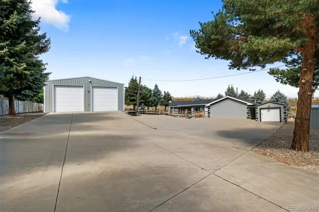 a view of a house with a yard and garage