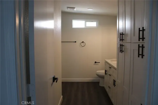 a bathroom with a granite countertop toilet and a shower