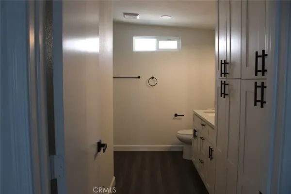 a bathroom with a granite countertop toilet and a shower
