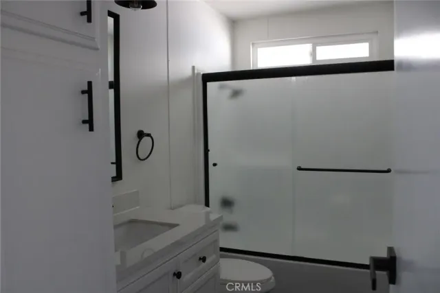 a bathroom with a shower and a sink