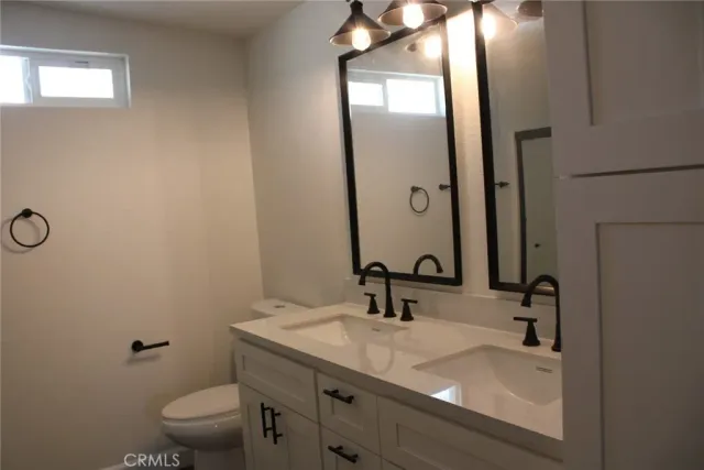 a bathroom with a sink toilet and mirror