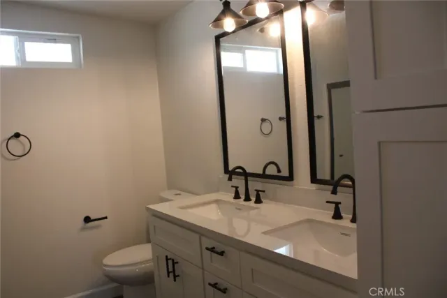 a bathroom with a sink toilet and mirror