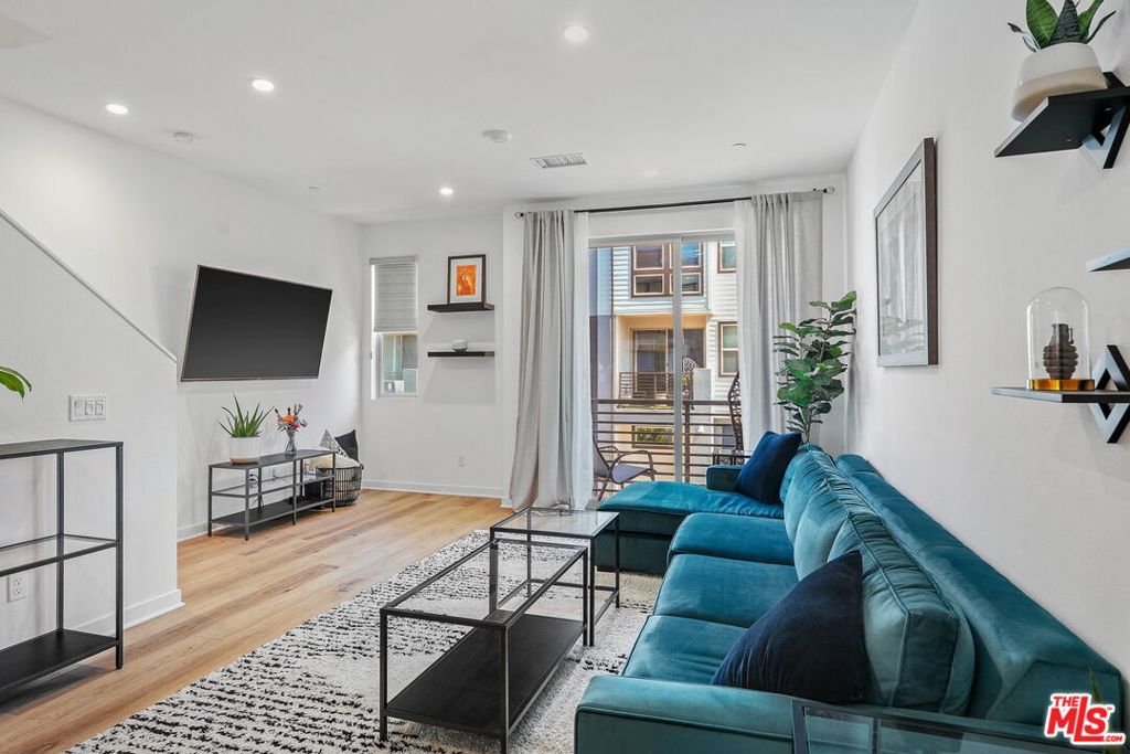 305 Placemark Irvine, CA 92614 - Photo 4 of 20 a living room with furniture and a flat screen tv