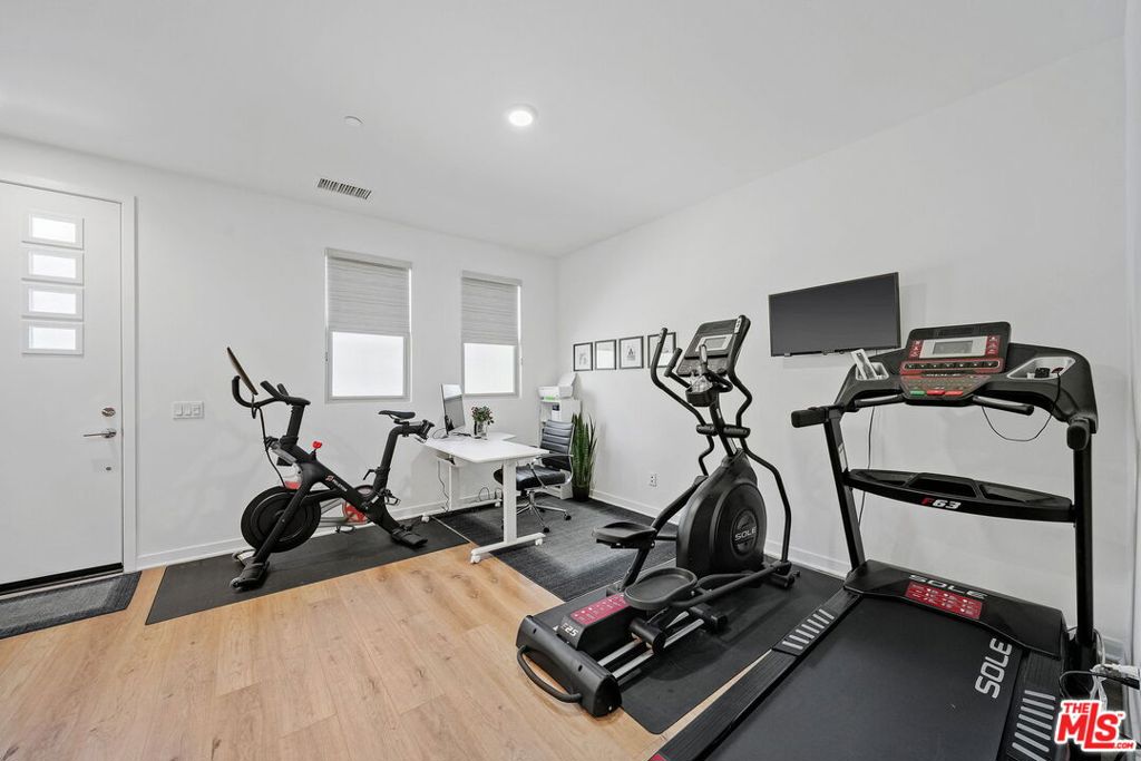 305 Placemark Irvine, CA 92614 - Photo 6 of 20 a room with gym equipment and wooden floor