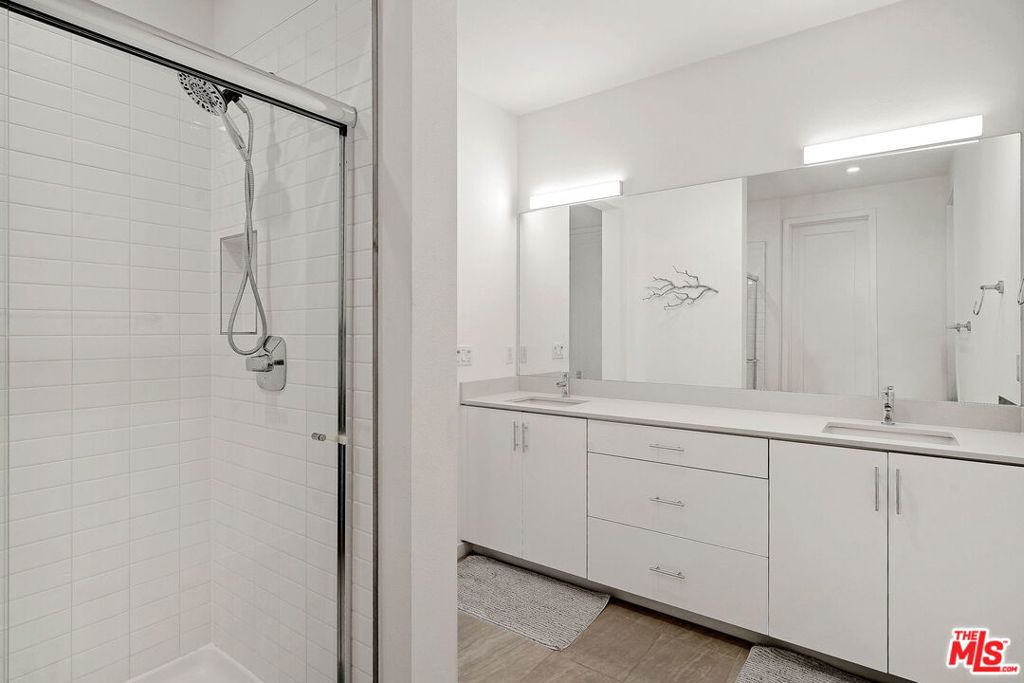 305 Placemark Irvine, CA 92614 - Photo 10 of 20 a bathroom with a double vanity sink and mirror