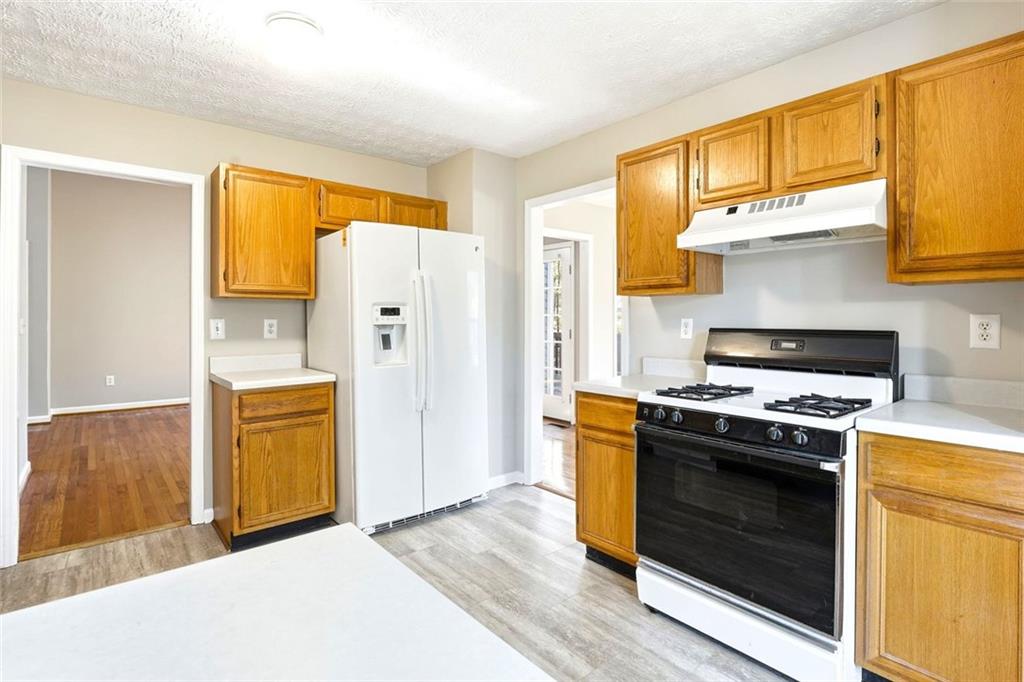 4099 Harvest Ridge Drive Douglasville, GA 30135 - Photo 18 of 46 a kitchen with stainless steel appliances granite countertop a stove and a refrigerator