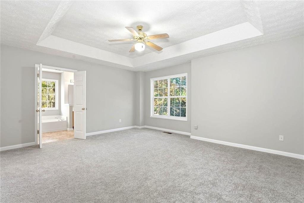 4099 Harvest Ridge Drive Douglasville, GA 30135 - Photo 19 of 46 an empty room with fan and windows