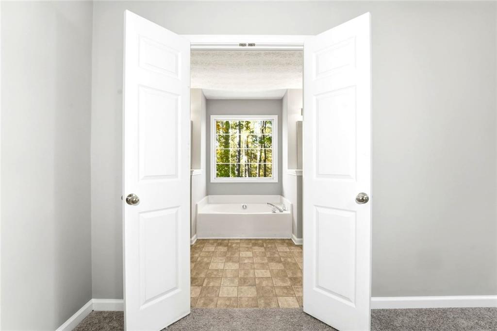 4099 Harvest Ridge Drive Douglasville, GA 30135 - Photo 23 of 46 a view of a hallway to an empty room with a window