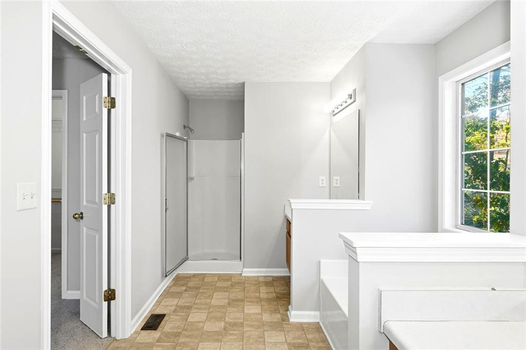 4099 Harvest Ridge Drive Douglasville, GA 30135 - Photo 25 of 46 a bathroom with a tub shower and sink