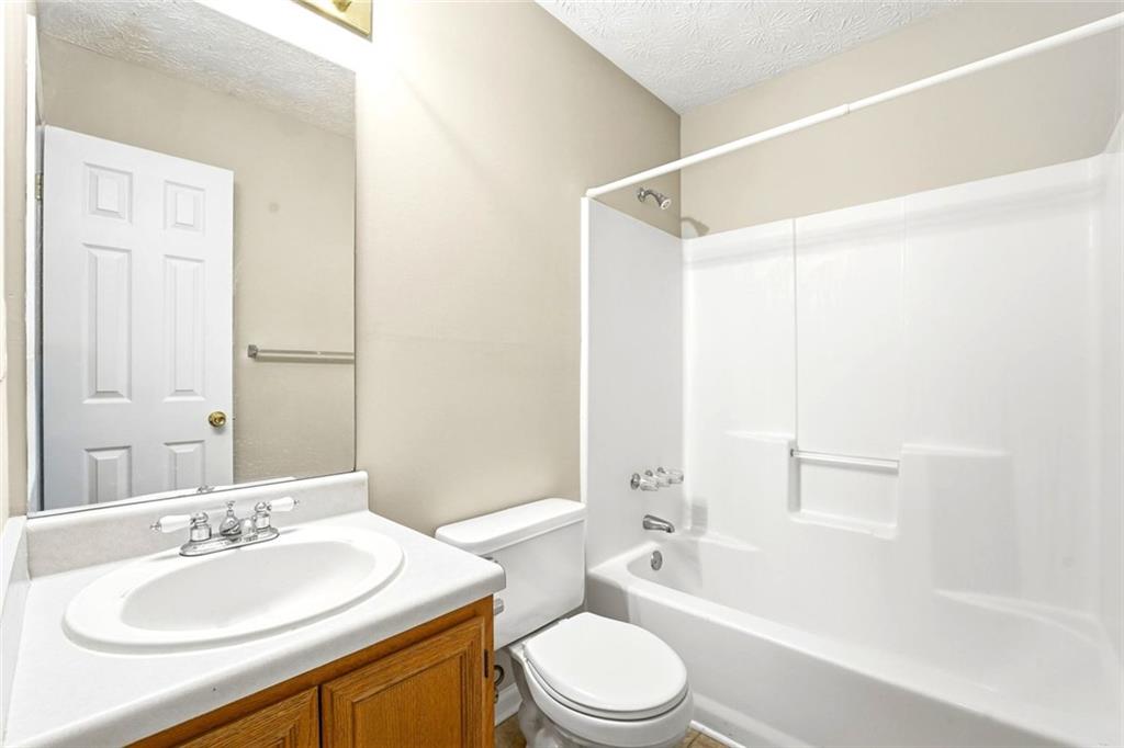 4099 Harvest Ridge Drive Douglasville, GA 30135 - Photo 29 of 46 a bathroom with a bathtub shower sink vanity mirror and toilet