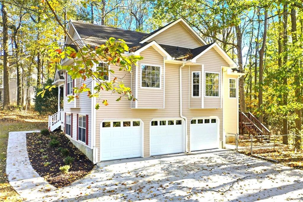 4099 Harvest Ridge Drive Douglasville, GA 30135 - Photo 3 of 46 a view of a white house with a large tree