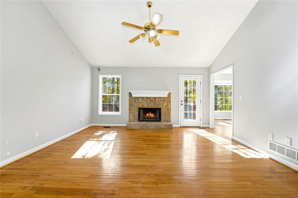 4099 Harvest Ridge Drive Douglasville, GA 30135 - Photo 10 of 46 a view of a livingroom with a fireplace a ceiling fan and wooden floor