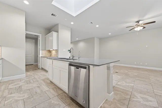 a kitchen with kitchen island cabinets and window