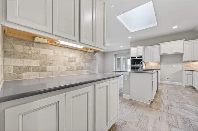 a kitchen with white cabinets