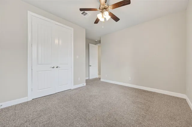 a view of empty room with a fan