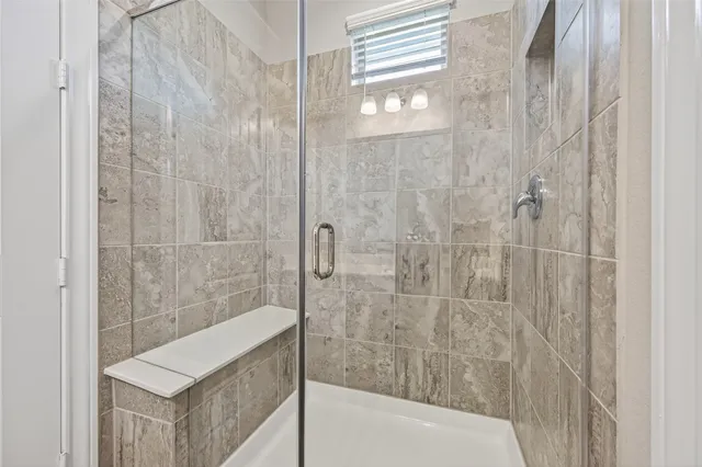 a bathroom with a bathtub and shower