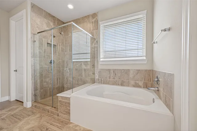 a white bath tub sitting next to a shower