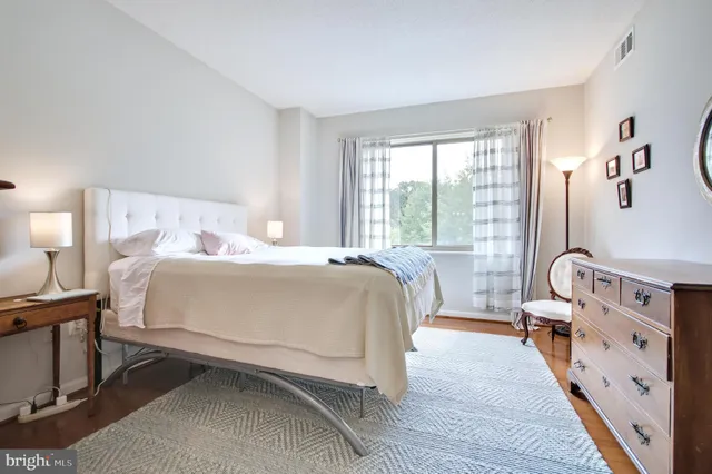 a bed room with a bed and a chair