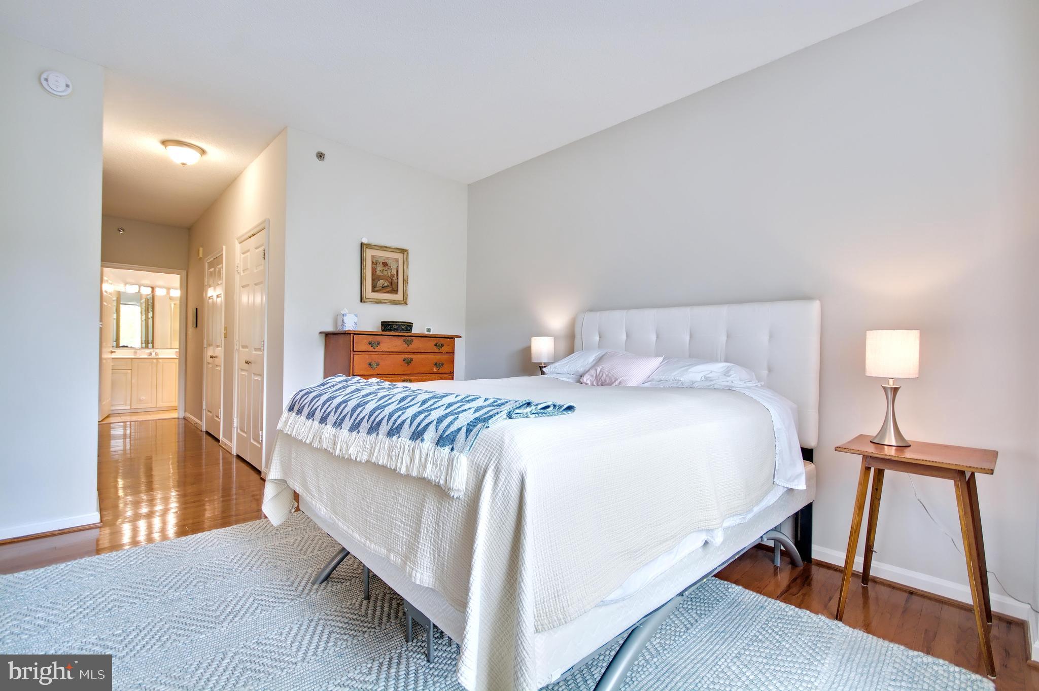 940 Astern Way, Unit 309 Annapolis, MD 21401 - Photo 23 of 52 a bedroom with a bed and wooden floor