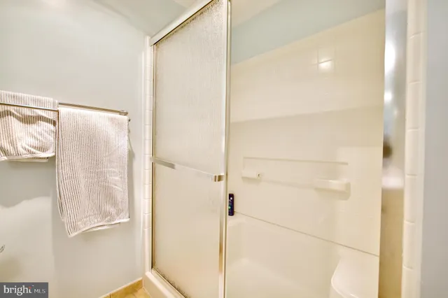 a bathroom with a glass shower door