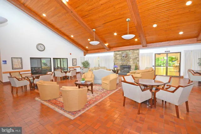 a living room with lots of furniture and a large window
