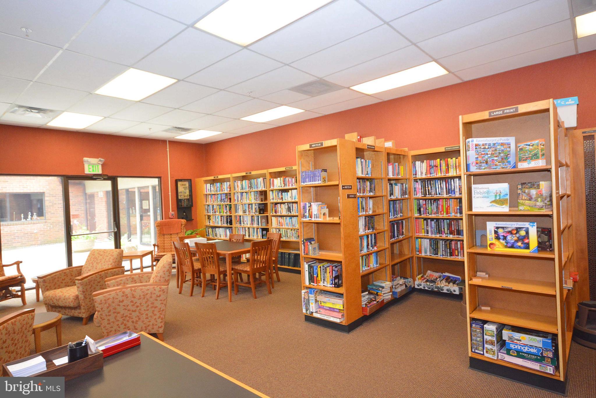 940 Astern Way, Unit 309 Annapolis, MD 21401 - Photo 36 of 52 a living room with furniture a bookshelf and a large window